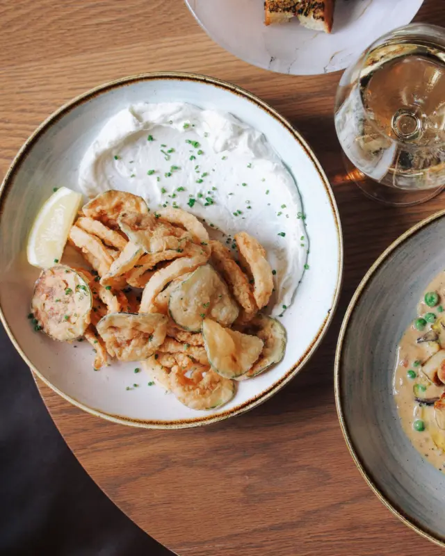 Crisp, golden, and impossible to share.

Our Calamari Fritti: bread crumbed perfection served with house-made tzatziki, zucchini chips, and a squeeze of lemon.
Light enough to start. Addictive enough to steal the show.

✨ Reserve your table and start the night right.